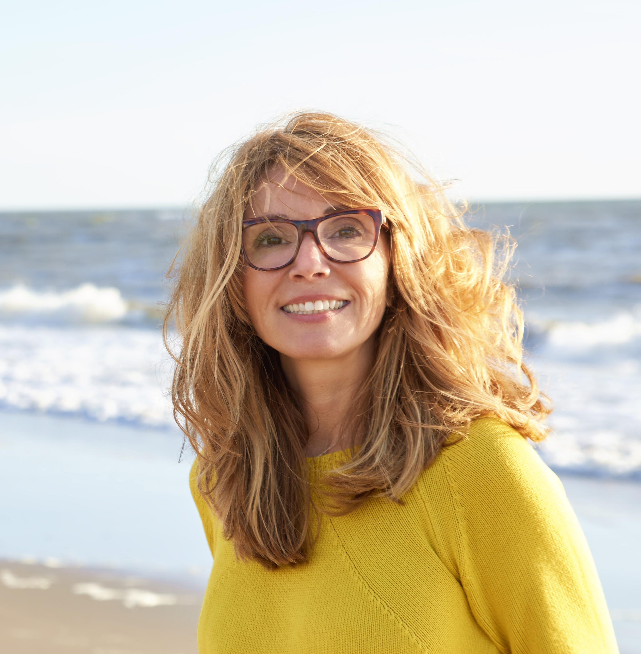 A woman smiling on the beach